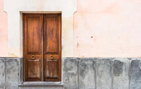 House wall background with rustic brown wooden front door Stock Photos