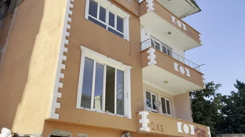 A house whose bottom floor collapsed in an earthquake. Stock Footage 246457511
