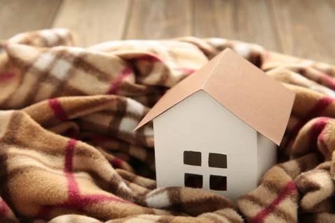 House in winter - heating system concept and cold snowy weather with model of Stock Photos