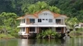 Houseboat amongst palms on the Koh-Chang island in Thailand HD Footage