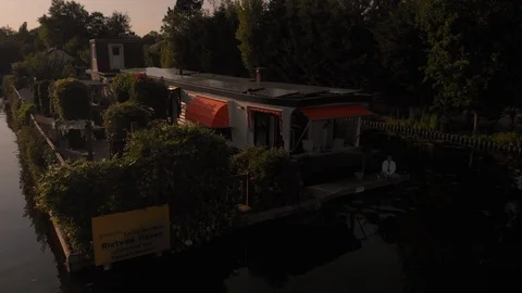 Houseboat Package 4 | fly over houseboat boathouse garden with solar panels Stock Footage 119585432