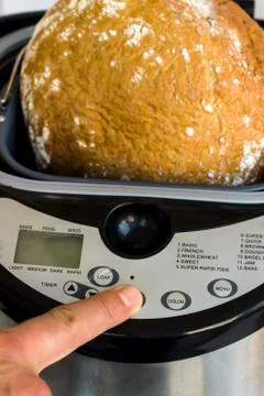 Household bread making machine,finger touching Foto stock