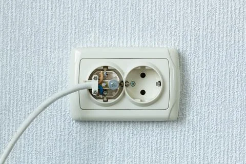 Household electrical outlet with a broken electrical plug inside. Wiring Devices Stock Photos