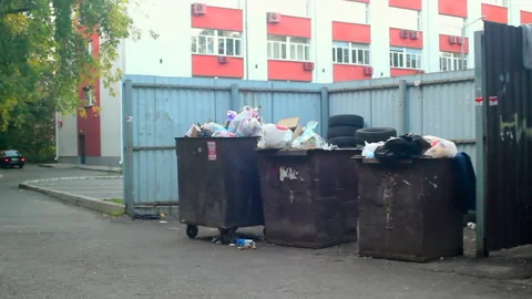 Household garbage in bins on the background of the building Stock Footage 210834489