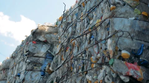 Household garbage in stacks, close up. Pressed trash is ready for recycling at a Video stock 94583602