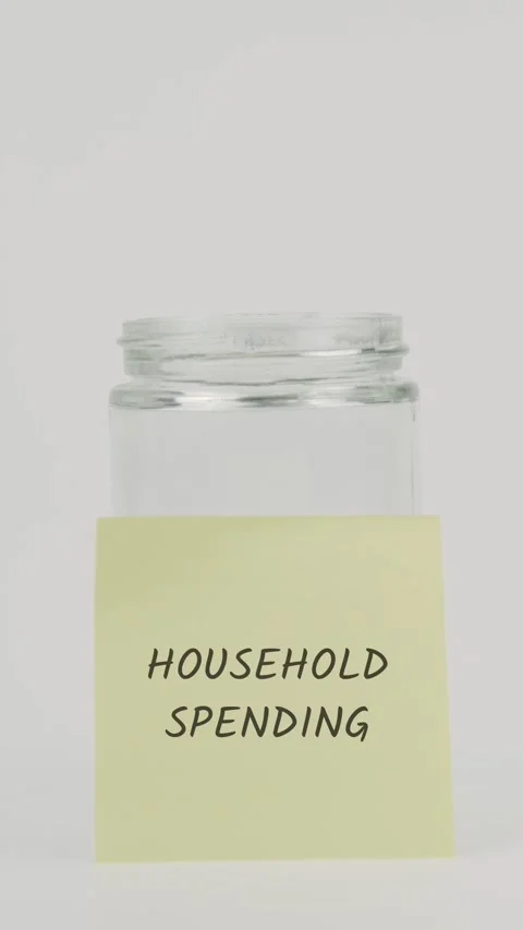 Household spending text or word on yellow sticky note attached to glass jar Stock Footage 311742419