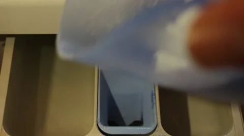 Housekeeper is adding powder to washing machine Stock Footage 48844902