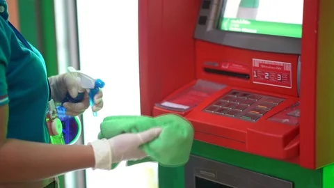 Housekeeper Cleaning the ATM Machine 库存影片 128571766