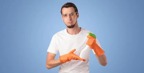 Housekeeper in front of a blue empty wall Stock Photos