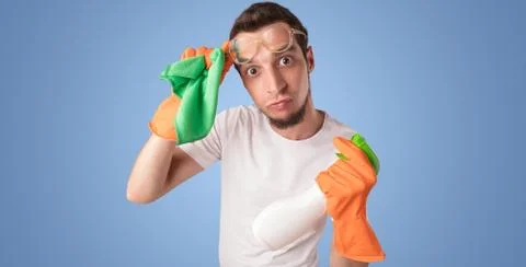 Housekeeper in front of a blue empty wall Stock Photos