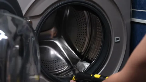 Housekeeper using modern steam cleaning to freshen up rubber collar of washing Stock Footage 294619369