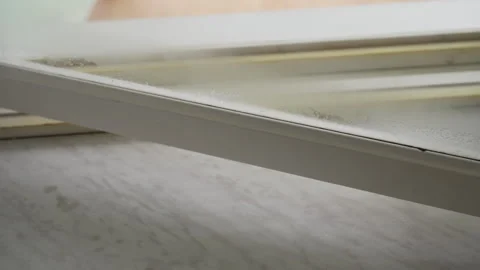 Housekeeper using steam cleaner to sanitizing window frames at home. Close-up of Stock Footage 311053571