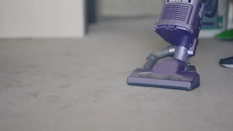 Housekeeping personal using purple vacuum cleaner on hotel carpet in cleanly  Stock Footage 311183149