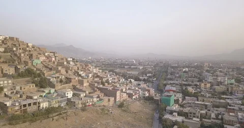 Houses on mountain's edge above the city, Kabul Afghanistan, drone 4k, ungraded Stock Footage