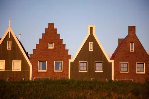 Houses with triangular roofs built side by side Stock Photos