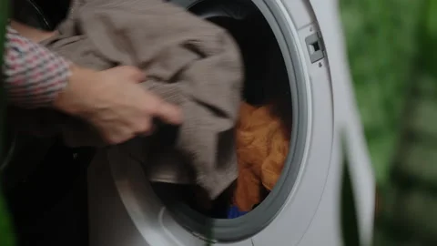Housewife doing laundry using washing machine. Stock Footage 253604258