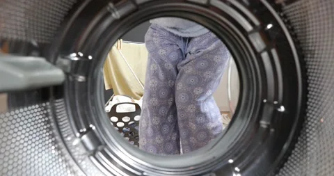Housewife drinking wine while doing the laundry. View from the washing machin Stock-Footage 152855254