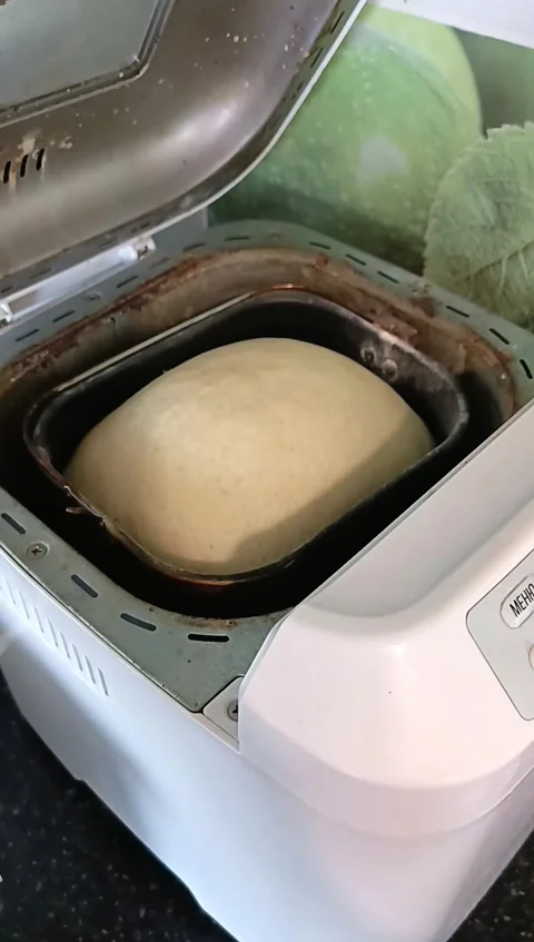 Housewife opens bread maker with baking white bread, checking its readiness Stock Footage 308485517