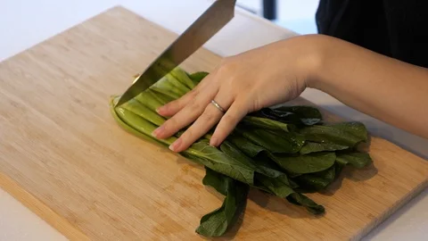 A housewife preparing spinach for dinner Stock Footage 121400906