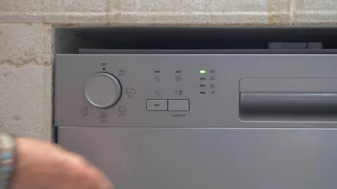 Housewife Selecting Dishwasher Program and Starting the Washing Cycle Stock Footage 337955798