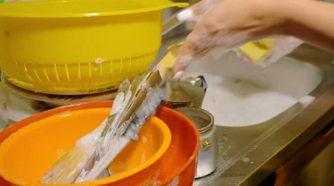 Housewife soaping knifes at the sink Stock Footage