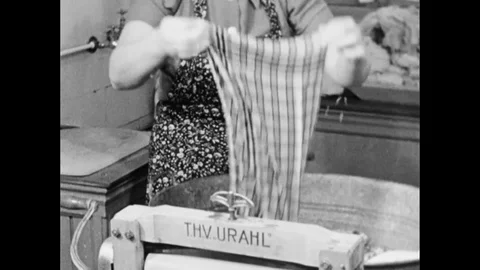 Housewife Sorting Textiles And Using A Laundry Mangle Press Stock Footage 91293334