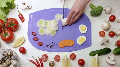 Housewife uses sharp knife to cut on chopping board Stock Footage 231225425