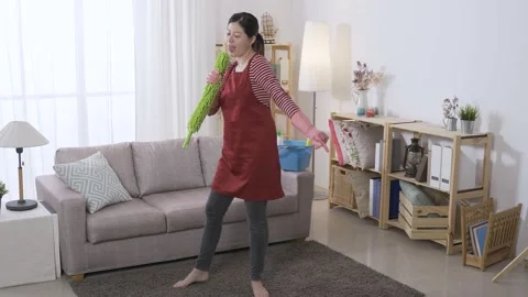 Housewife using a duster boom as a microphone Stock Footage 154029104