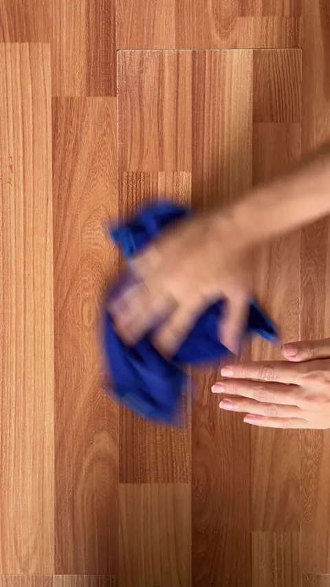 A housewife is using a soft cloth and cleaning solution to keep the house clean. Stock Footage 337354864
