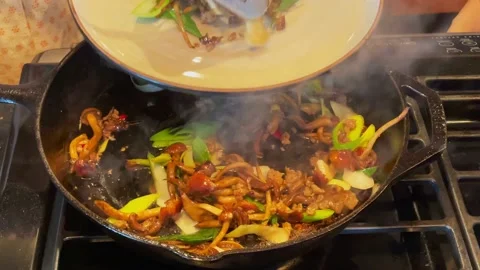Housewives are using a flat iron wok to fry vegetables Stock Footage 169937386
