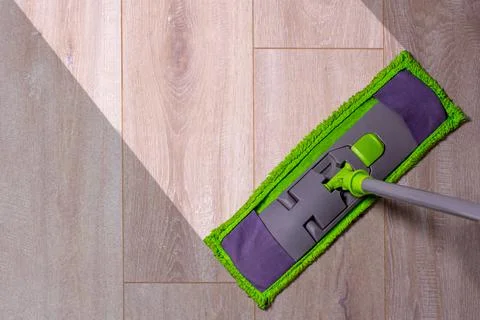 Housework - sweeper wet mop on laminate floors. Stock Photos