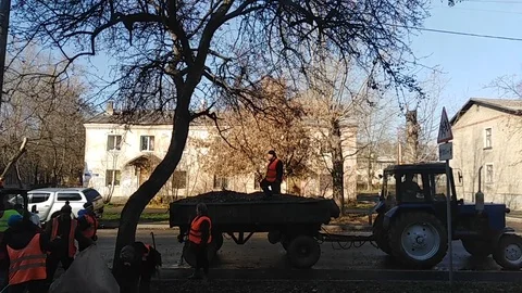 Housing workers clean street from foliage. Russia Stock Footage
