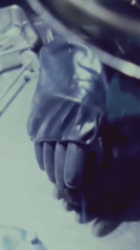 HOUSTON - 1969 - Gloved hands split a lunar rock in two in a NASA vacuum lab. Video stock 342909329