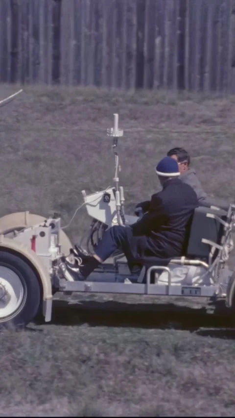 HOUSTON - 1971 - A NASA engineer oversees Charles Duke backing up a lunar rover Stock Footage 340303149