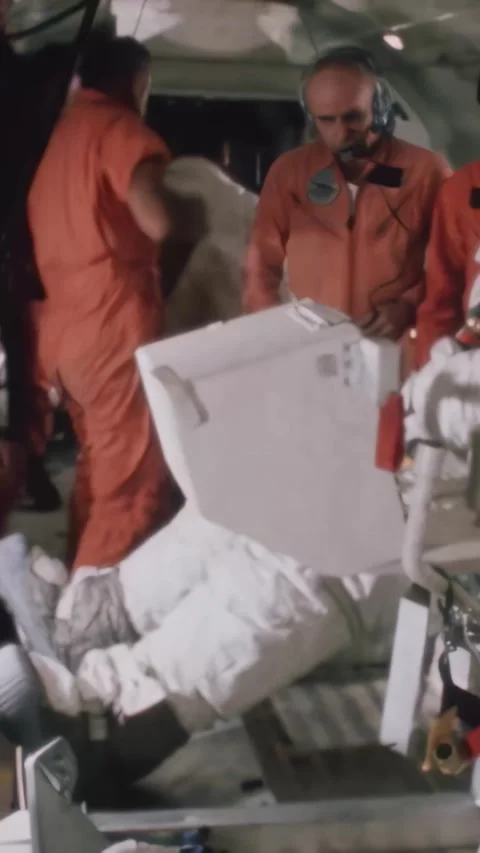 HOUSTON - 1971 - Side view of a NASA astronaut putting on a safety belt on a Stock Footage 340303540