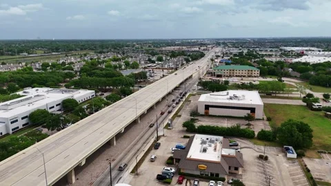 Houston, Texas, US - 04.03.2026: An elevated highway overpass stretches through Video stock 337825246
