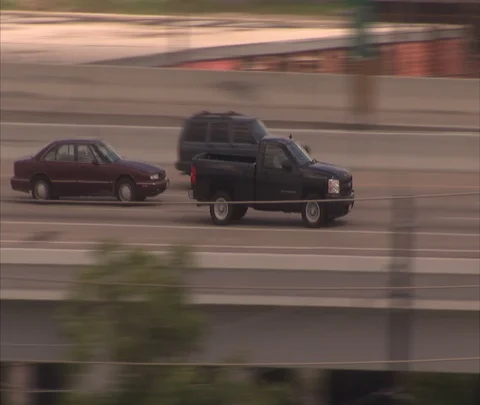 Houston, TX; MS camera tracks dark colored SUV moving fast on highway ramp Stock Footage 86697817
