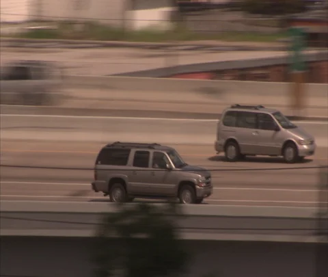 Houston, TX; MS camera tracks gray SUV moving on highway ramp Stock Footage 86697845