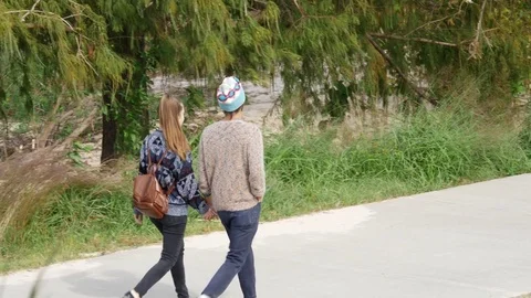 Houston TX Oct 2017  Young Couple Walking Along Pathway Cool Day Stock Footage 83966165