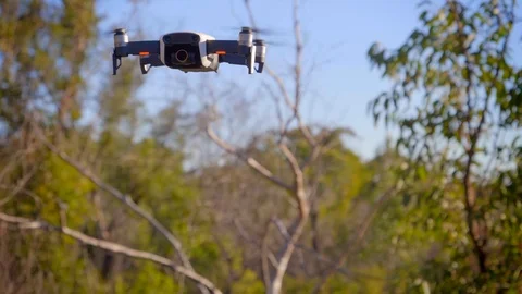 Hover and landing of white DJI mavic air on rock Stock Footage 112584949