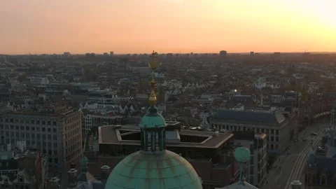 Hover around Dam Square Palace, golden cone, Aerial sunset shot Stock Footage 136724706