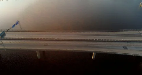 Hover over bridge with morning traffic and morning sun Stock Footage 124007261