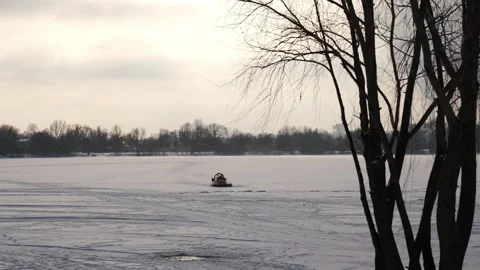 Hovercraft driving at high speed on snow covered frozen ice surface of lake Stock Footage 326774789
