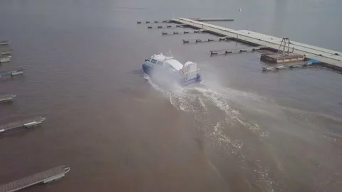 Hovercraft with large propeller sails along wide river Stock Footage 155286703