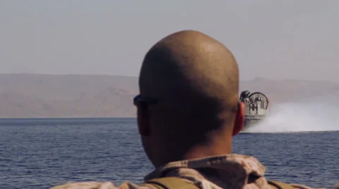 Hovercraft Passing Soldiers 01 Stock Footage 28798322