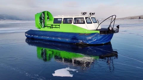 Hovercraft stands on frozen ice surface lake baikal and reflected on surface. Stock Footage 230212043