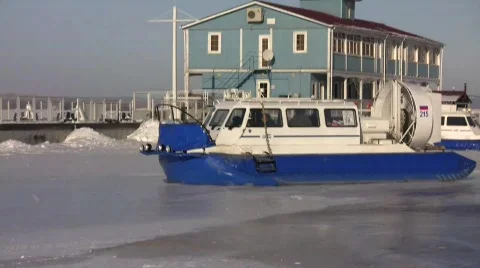 Hovercrafts crossing frozen river Stock Footage 694586