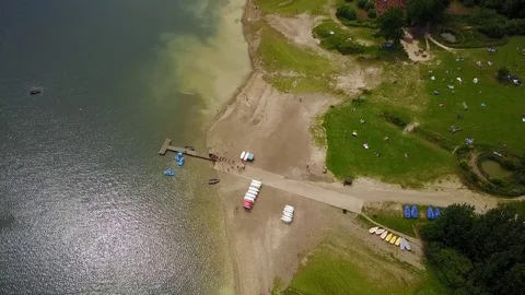 Hovering above Bewl Water lake reservoir jetty in Lamberhurst, East Sussex Stock Footage 77074409