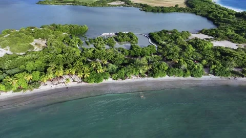 Hovering above famous Salines Beach, panning left and up along the beach  Stock Footage 324788185
