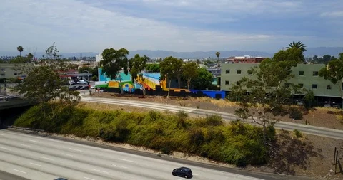 Hovering above freeway suburbs in back Stock Footage 114031870
